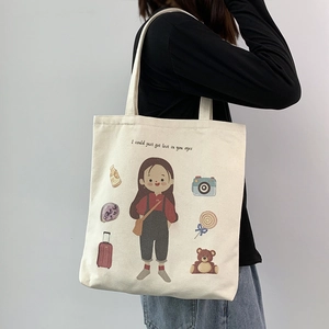 Detail of canvas tote bag with artistic girl illustration and lovely slogan print