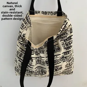 Detail view of durable off-white canvas tote with dual-sided text print and zipper closure