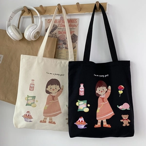 Detail of canvas tote bags featuring cute girl illustrations and a wooden hanger setup