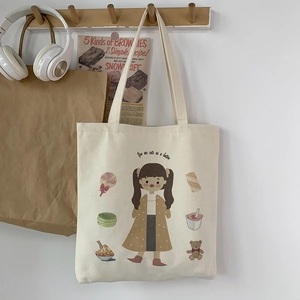 Detail of canvas tote bag with cute cartoon girl illustration and sweet dessert patterns