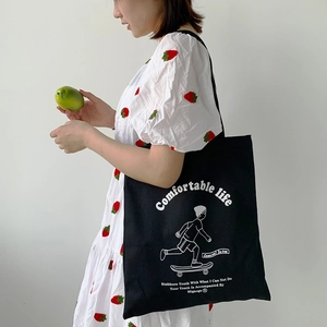 Thick black canvas tote bag with skater boy print and comfortable life slogan for women