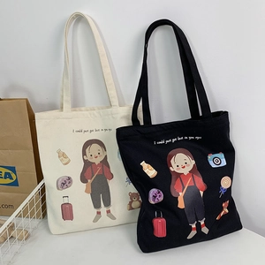 Detail view of canvas tote bags featuring artistic hand-drawn girl illustration and text