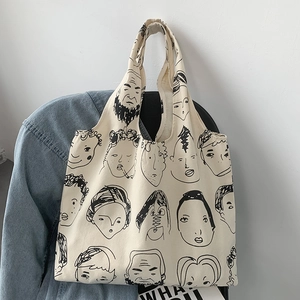 Detail of artistic canvas tote bag with portrait illustration on denim jacket