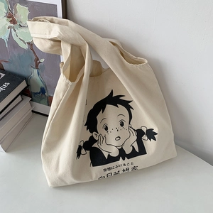 Détail d'un sac cabas en toile avec imprimé de dessin animé et texte bilingue