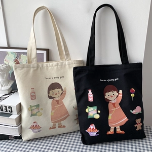 Cute canvas tote bags with cartoon illustrations in black and beige displayed with books
