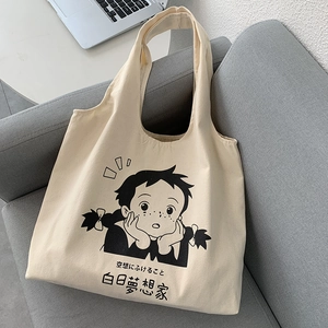 Détail du sac cabas en toile avec illustration de fille d'anime et texte japonais