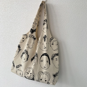 Close-up of artistic hand-drawn portraits on high-density cotton canvas tote bag