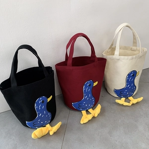 Detailed close-up of colorful canvas lunch bags featuring cute 3D duck foot designs