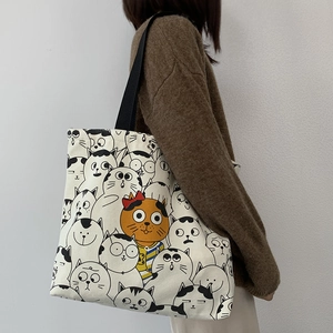 Canvas tote bag with cute cartoon cat prints and sturdy black shoulder straps