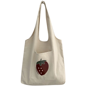Minimalist canvas tote bag with strawberry graphic print and front storage pocket