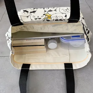 Detailed interior of canvas tote bag showing large capacity for books and tablet