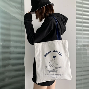 Detail of thickened canvas tote bag with skateboarder print and blue shoulder straps