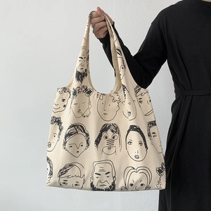 Close-up of minimalist canvas tote bag with abstract artistic line portrait print
