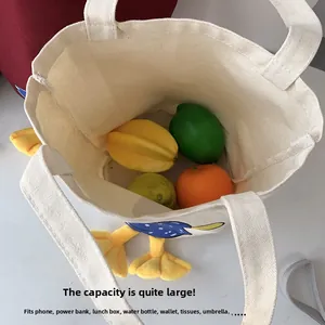 Spacious interior of canvas lunch tote with 3D duck feet design and ample storage capacity