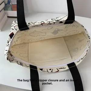 Detail of canvas tote bag featuring secure zipper closure and internal storage pocket