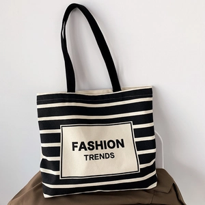 Minimalist black and white striped canvas tote bag with Fashion Trends lettering
