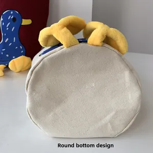 Detail of the unique circular base design and textured off-white canvas of the bento bag