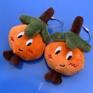 Detail of plush orange fruit charms with cute faces and durable steel wire rings