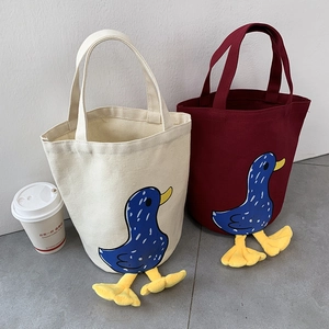 Detail of canvas lunch bag featuring 3D plush duck feet and cute cartoon patterns