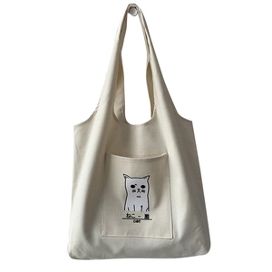 Minimalist canvas tote bag with a cute cat print and a functional front pocket