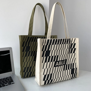 Detail view of large canvas tote bag with ABLE graphic and geometric pattern print