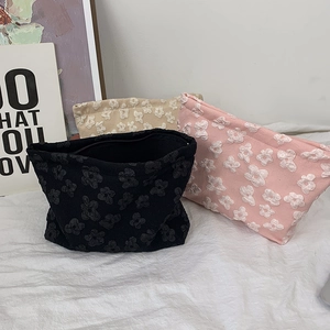 Floral embossed makeup bags in black pink and beige with 3D flower texture