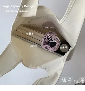 Detailed interior view of a large canvas tote bag showing storage capacity for laptop and books