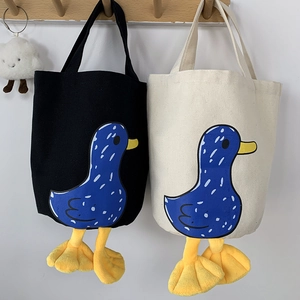 Detail of canvas lunch bags with creative 3D plush duck legs and blue polka dot duck prints