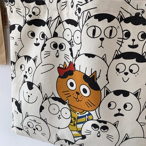 Canvas tote bag with cute hand-drawn cartoon cat prints and orange feline center design