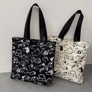 Detailed pattern of cartoon dog prints on black and beige canvas tote bags