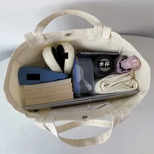 Top view of cream canvas tote bag showing large capacity for laptop, shoes and clothes