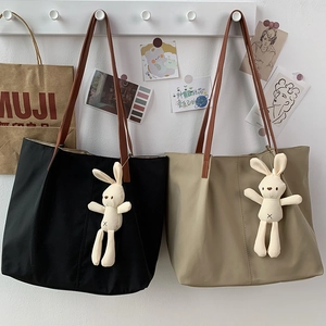Minimalist nylon canvas tote bags in black and khaki colors with cute rabbit pendant
