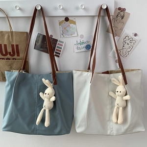 Minimalist canvas tote bag with leather straps and cute rabbit charm in gray and white