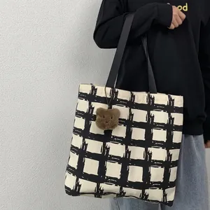 Large capacity black and white checkered canvas tote bag with a brown teddy bear pendant