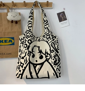 Detail of cute doodle canvas tote bag with cartoon art on a wooden hanger display