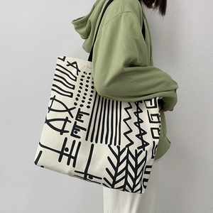 Large capacity canvas tote bag with abstract black patterns and wide shoulder straps