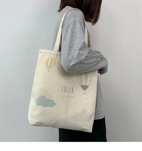 Detail view of large canvas tote bag with colorful hot air balloon print and shoulder strap
