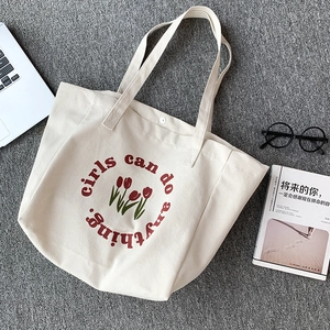 Minimalist canvas tote bag with red tulip print and girls can do anything slogan