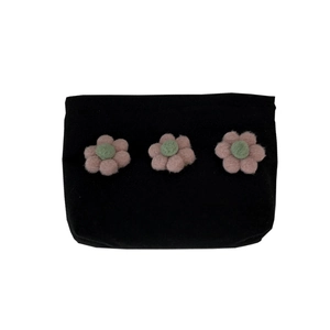 Portable black canvas makeup bag featuring three 3D plush flowers for travel storage