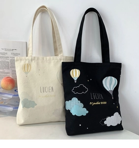 Detail of high-density canvas tote bags with hot air balloon prints and French text