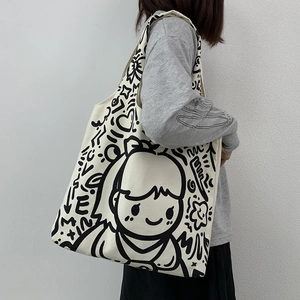 Detail of canvas tote bag showing artistic girl character graffiti and star heart prints