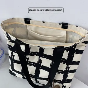 Detail of canvas tote bag featuring secure zipper closure and internal storage pocket