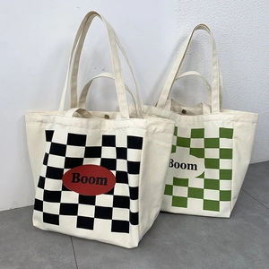 Detail of canvas tote bag showing magnetic snap closure and checkerboard print interior