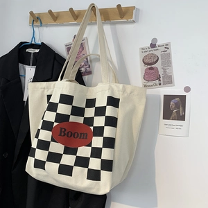 Detailed close-up of a vintage canvas tote bag with checkerboard pattern and red logo