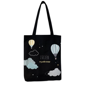 Large black canvas tote bag featuring hot air balloon illustration and shoulder straps