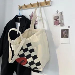 Detail of canvas tote bag showing side gusset and large capacity for travel use