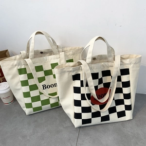 Detail view of large canvas tote bag with checkerboard pattern and secure snap button closure