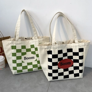 Canvas tote bags with checkerboard patterns and Boom text shown in a lifestyle scene