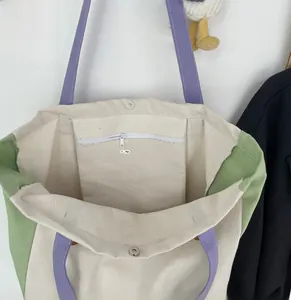 Detailed view of canvas tote bag interior with magnetic closure and zippered inner pocket