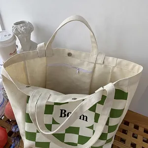 Large capacity canvas tote bag with green checkerboard pattern and Boom lettering print